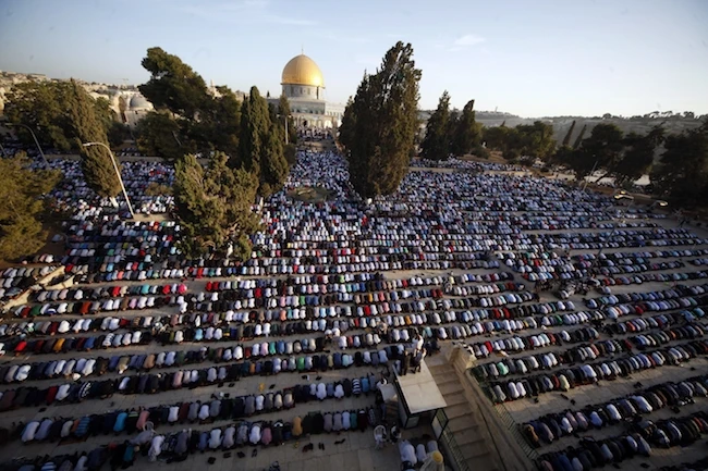 Above, Muslims pray near the Dome of the Rock Mosque in the Al-Aqsa Mosque compound in Jerusalem’s old city. Washington’s Middle East allies all warned against the dangerous repercussions of his decision when US President Donald Trump spoke to them on Tuesday. (AP)