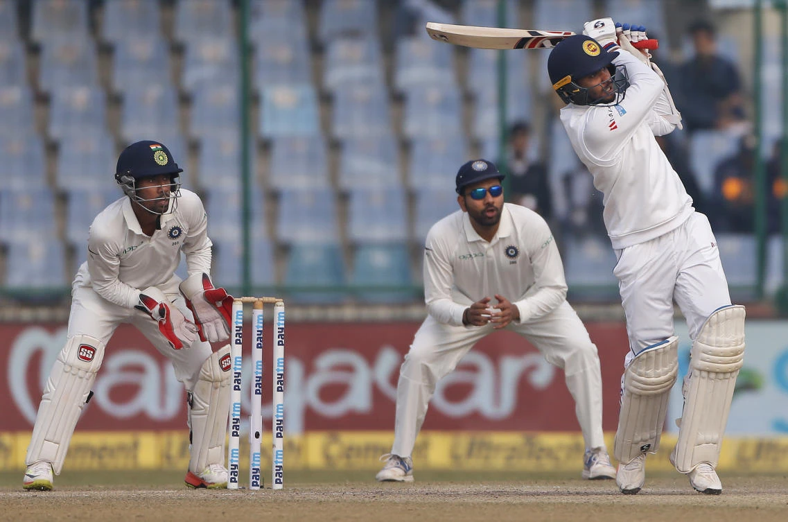 Sri Lanka’s Dhananjaya De Silva, right, plays a shot during the fifth day of their third test cricket match against India in New Delhi, India, Wednesday, Dec. 6, 2017. (AP Photo/Altaf Qadri)