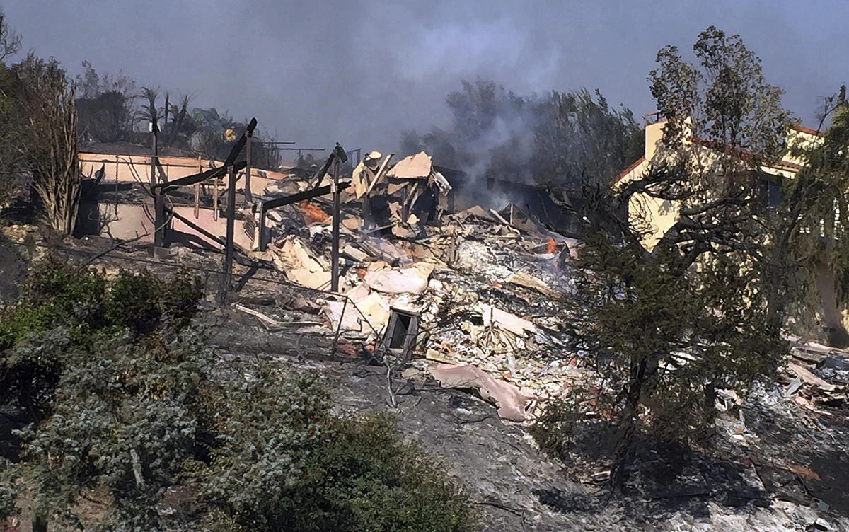 Above, Bob Pazen’s home is a smoldering ruin after a wildfire swept through Ventura, California on Tuesday, December 5. The ferocious wind-driven fires that destroyed at least 150 other structures in Pazen’s community. (AP)