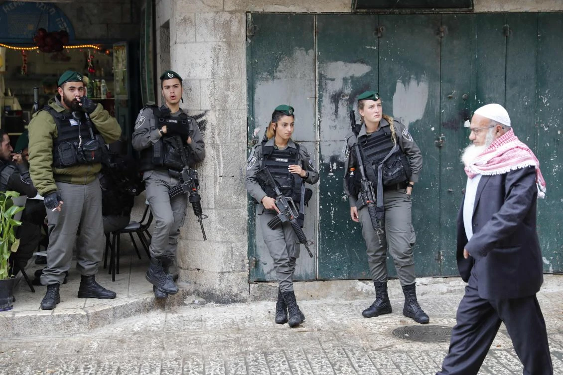 A Palestinian man walks past Israeli border guards standing in Jerusalem’s old city just after Damascus’ Gate on Dec. 6, 2017. President Donald Trump is set to recognize Jerusalem as Israel’s capital, upending decades of careful US policy and ignoring dire warnings from Arab and Western allies alike of a historic misstep that could trigger a surge of violence in the Middle East. (AFP/Thomas Coex)