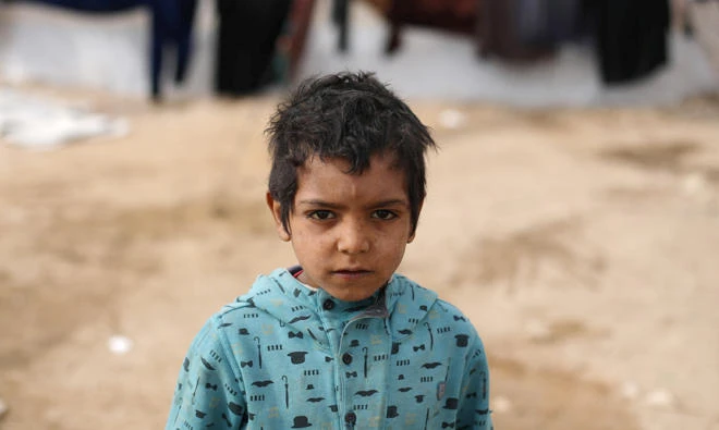 An internally displaced boy who fled Deir Al-Zor is pictured at Qana refugee camp in the southern Hasakah, Syria on November 26, 2017. (Reuters)