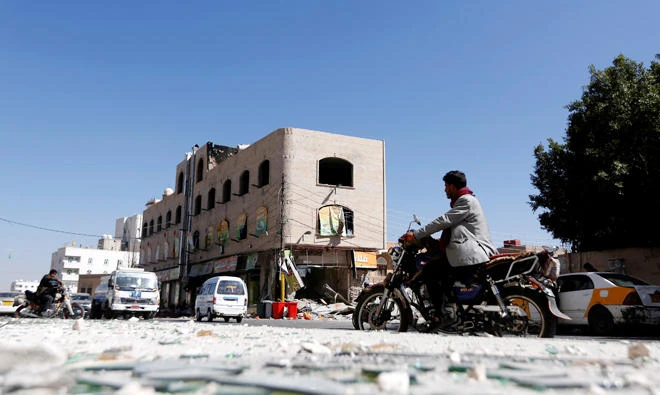 A man rides a motorbike on a street where Houthis have recently clashed with forces loyal to slain Yemeni former president Ali Abdullah Saleh in Sanaa, Yemen, on December 6, 2017. (Reuters)
