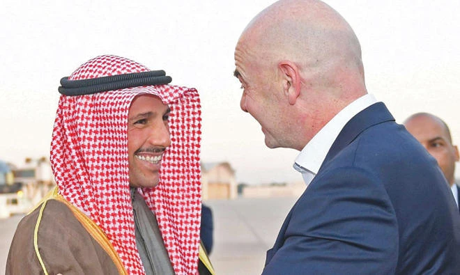 Kuwaiti national assembly speaker Marzouq Al-Ghanim greets FIFA president Gianni Infantino at Kuwait international airport (AFP)