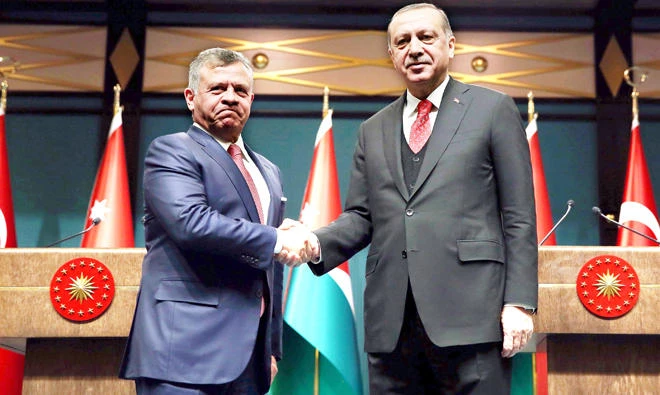 Turkish President Recep Tayyip Erdogan, right, shakes hands with Jordan's King Abdullah II after a joint press conference at the presidential complex in Ankara on Wednesday. (AFP)