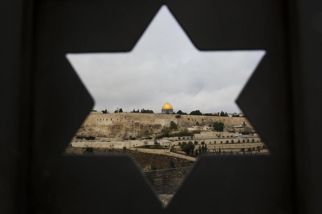 Jerusalem Old City is seen trough a door with the shape of star of David, in Jerusalem, Wednesday, Dec. 6, 2017. (AP/Oded Balilty)