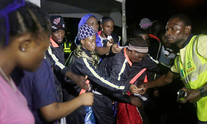 Nigerian returnees from Libya hand over their baggage tags to an official of National Emergency Management Agency after been process upon arrival at the Murtala Muhammed International Airport in Lagos, Nigeria, on Tuesday, Dec. 5, 2017. Hundreds of Nigerians arrived in Lagos, having been repatriated by the African Union. (AP)