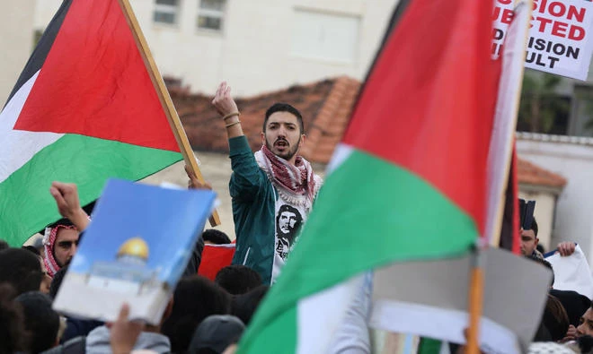 Protesters shout slogans and wave the Jordanian flag during a protest near the American Embassy in Amman against US President Donald Trump's decision to recognise Jerusalem as the capital of Israel on Thursday, December 7, 2017. (AFP)