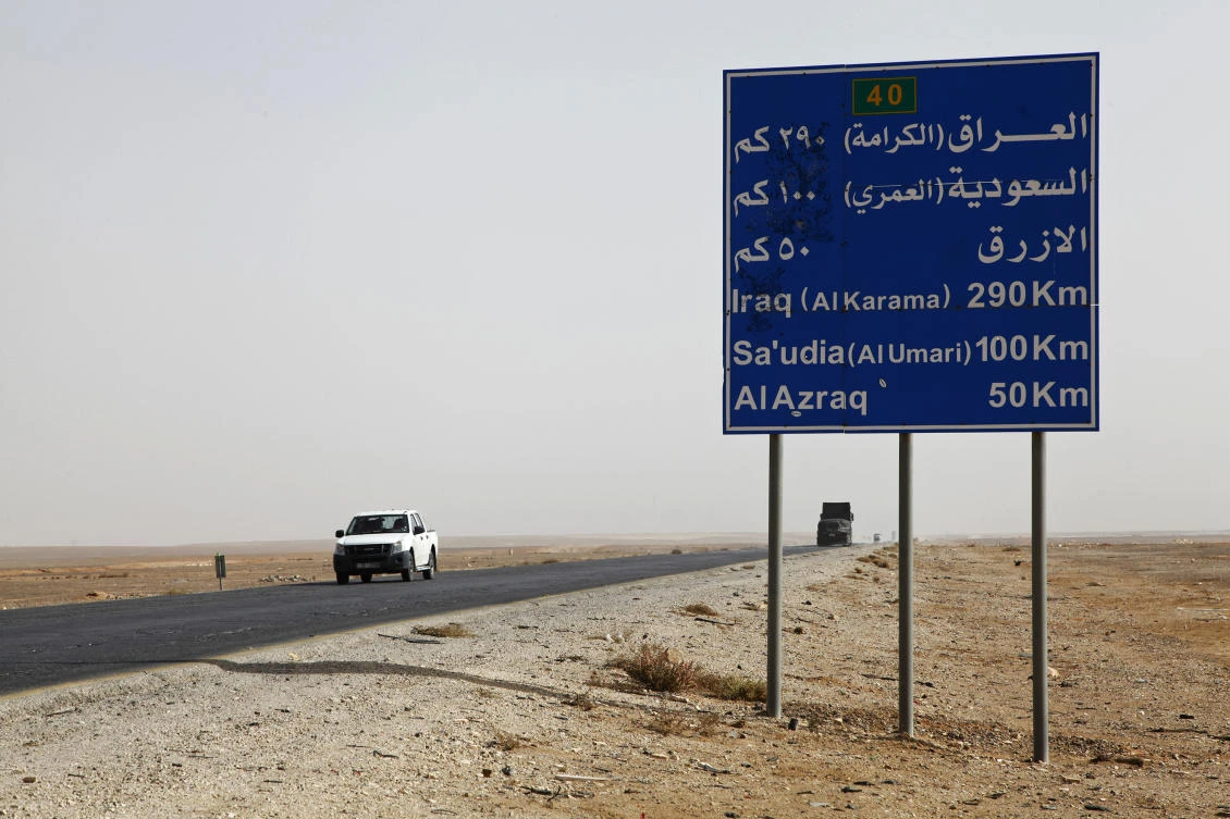 Above, a car passes a sign on a desert highway where the Jordanian government announced it will build a yet-to-be-named city, with the first phase to be completed by 2030 and the entire project by 2050. (AP)