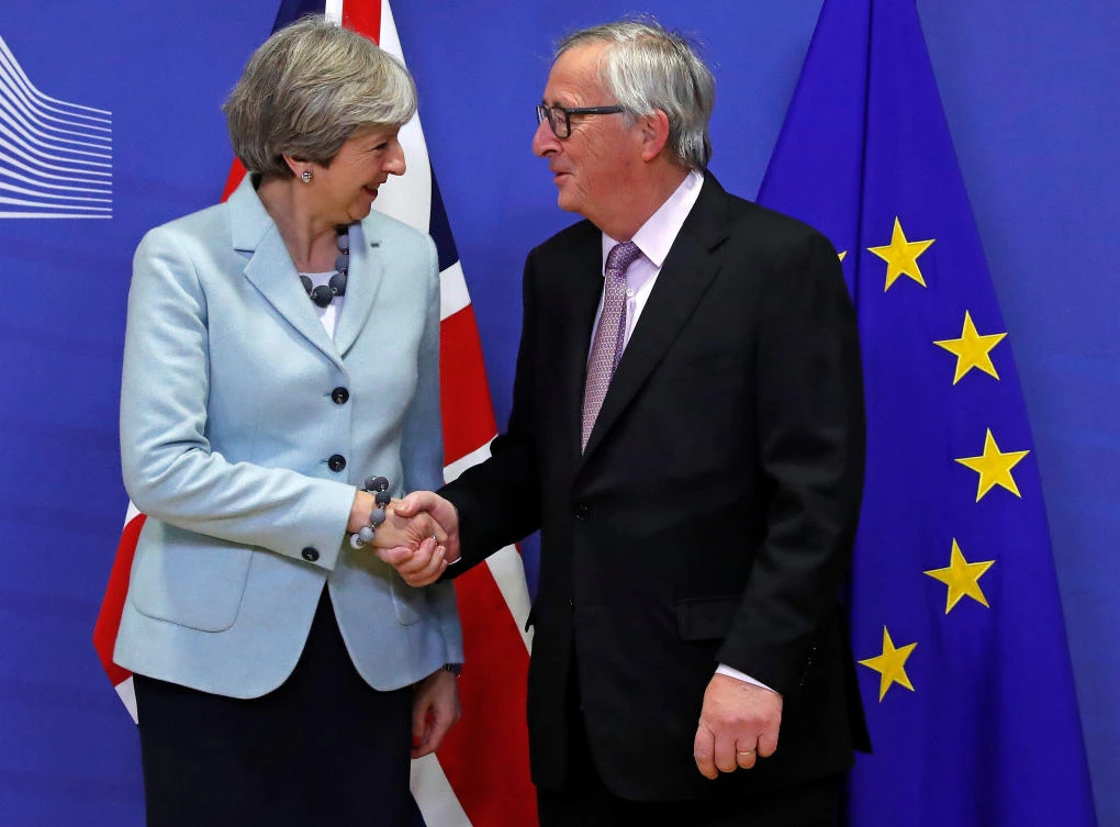 Britain’s Prime Minister Theresa May, left, is welcomed by European Commission President Jean-Claude Juncker at the EC headquarters in Brussels on Friday, December 8. The two announced that the second phase of Brexit negotiations should begin, ending an impasse over the status of the Irish border. (Reuters)