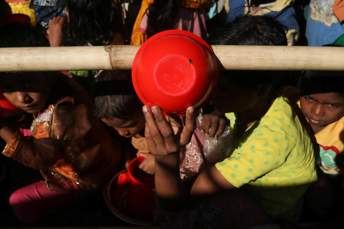 Above, a Rohingya refugee uses a bowl to protect herself from the sun as she waits to receive a hot meal from a relief agency at Mainnerghona refugee camp near Cox’s Bazar in Bangladesh. Almost 700,000 Rohingya evacuees are camped in refugee camps in Bangladesh after escaping violence in neighboring Myanmar. (Reuters)
