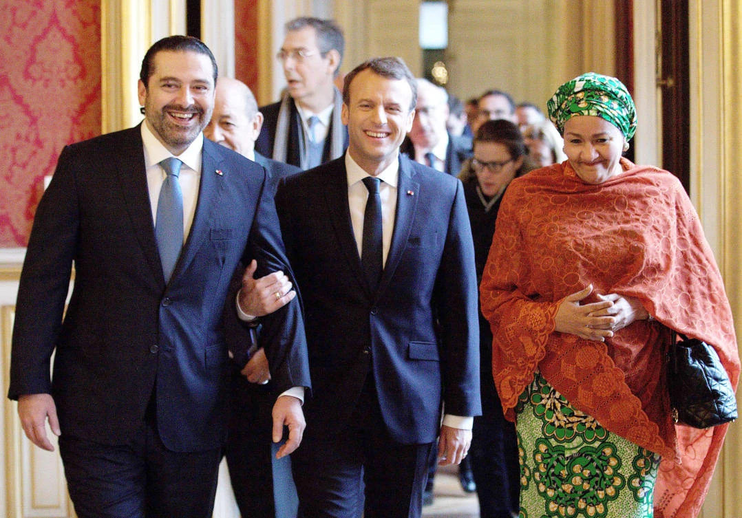 French President Emmanuel Macron walks with Lebanon’s Prime Minister Saad Hariri as they arrive to attend the Lebanon International Support Group meeting in Paris on Friday. (AFP)
