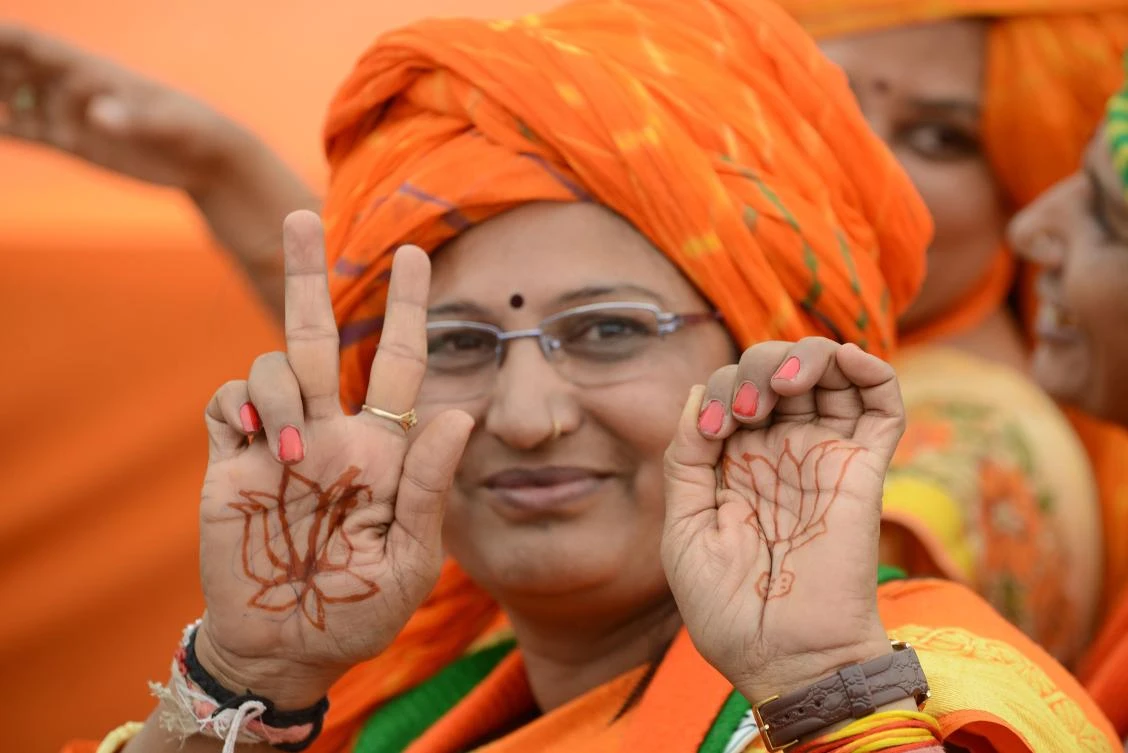 A supporter of Bharatiya Janata Party gestures as she participates in a rally of Indian Prime Minister Narendra Modi. Voters had started lining up at polling booths early in the morning in Gujarat where Modi’s BJP has held power for 22 years. (AFP)