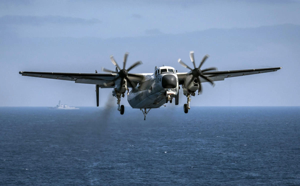 A file image provided by the US Navy, a C-2A Greyhound assigned to the Providers of Fleet Logistics Support Squadron 30, prepares to land on the flight deck aboard the aircraft carrier USS Theodore Roosevelt on August 22, 2017. (Navy Office Information)