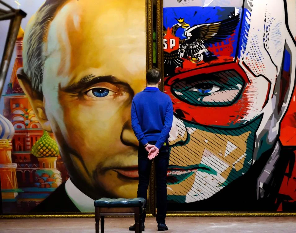 A man looks at a painting depicting Russian president Vladimir Putin at the “SUPERPUTIN” exhibition of the Museum of Ultra-Modern Art in Moscow. (AFP)