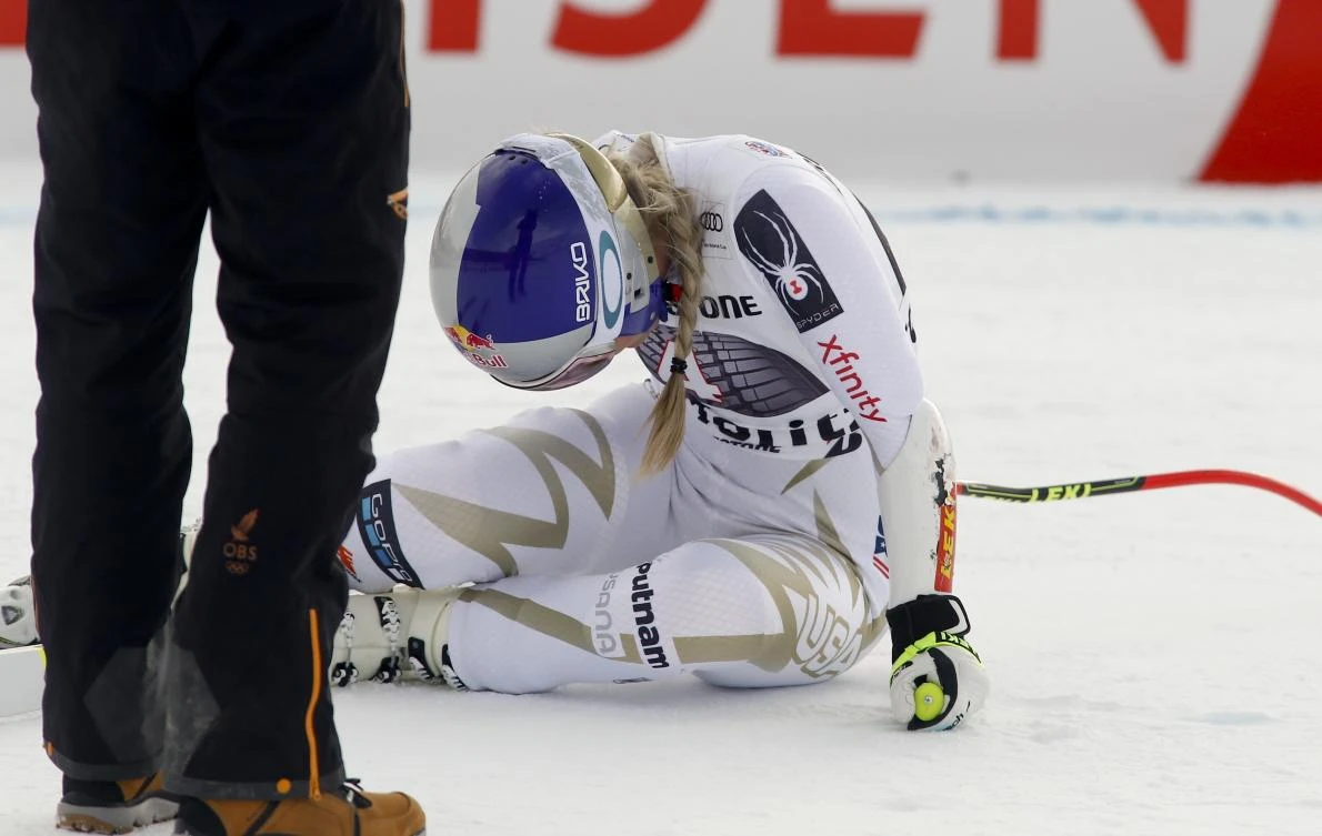 American skier Lindsey Vonn lies on the snow in pain after completing an alpine ski run at World Cup Super-G in St. Moritz, Switzerland on Saturday, December 9. (AP)