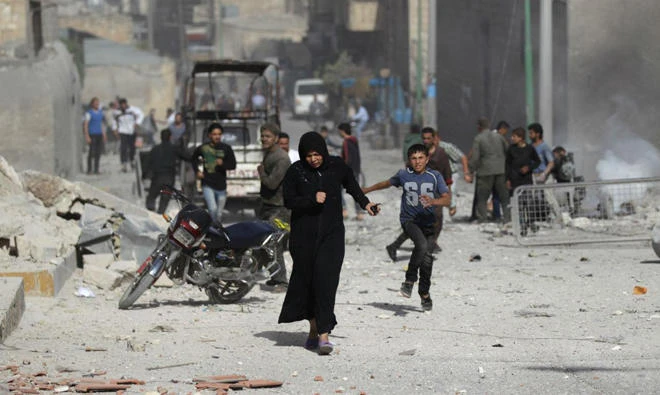 A woman runs after an airstrike in Idlib, Syria. (File photo/Reuters)