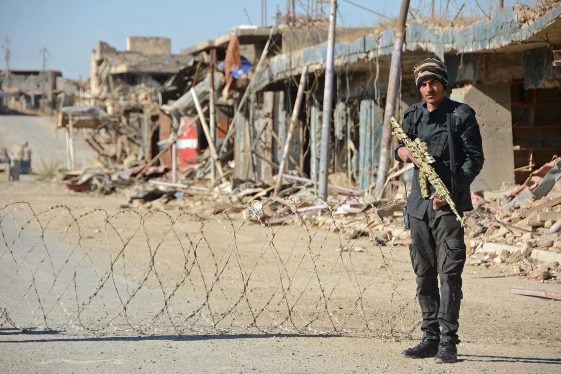 A member of the Iraqi forces guards a checkpoint in the northern Iraqi city of Baiji on Nov. 27, 2017. Two years after the jihadists of Daesh were forced from this one-time industrial hub, Baiji remains a devastated ghost city as pledges of funds to help rebuild life have failed to materialize. (AFP/Mahmud Saleh)
