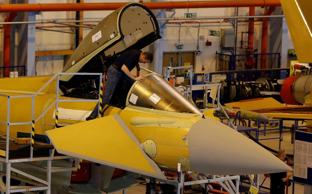 A member of staff works in the cockpit of an aircraft on the Eurofighter Typhoon production line at BAE systems Warton plant near Preston, northern England September 7, 2012. (Reuters)