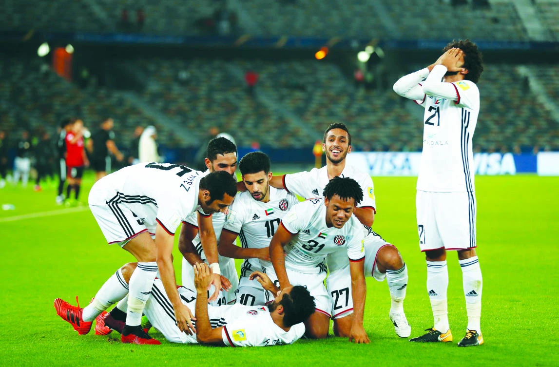 Al-Jazira players celebrate their win against Urawa Reds, the victory that got them through to the FIFA World Club Cup semi-final against Real Madrid. (Reuters)