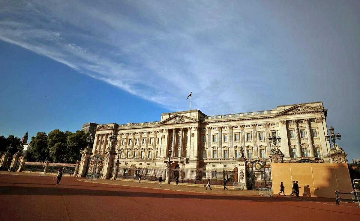 In this file photo, people walk past a protective board outside Buckingham Palace in London, Britain, Sept.14, 2017. (REUTERS)