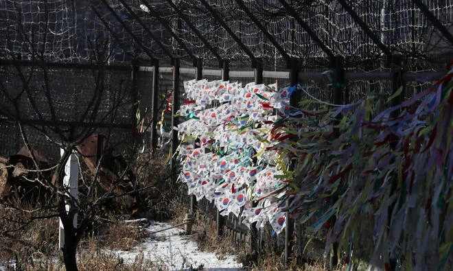 South Korean national flags and ribbons carrying messages to wish for the reunification of the two Koreas flutter at the Imjingak Pavilion in Paju, South Korea, Monday. South Korea added several North Korean groups and individuals to its sanctions list Monday in a largely symbolic move that is part of efforts to cut off funding for the North's weapons programs. (AP)