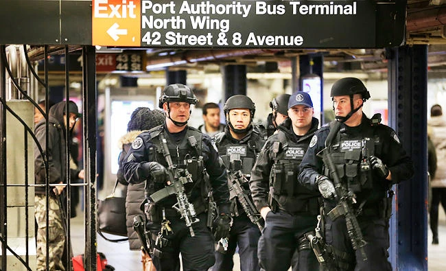 Police officers patrol in the Port Authority Bus Terminal in New York, on Tuesday, near the site of Monday's explosion. (AP)
