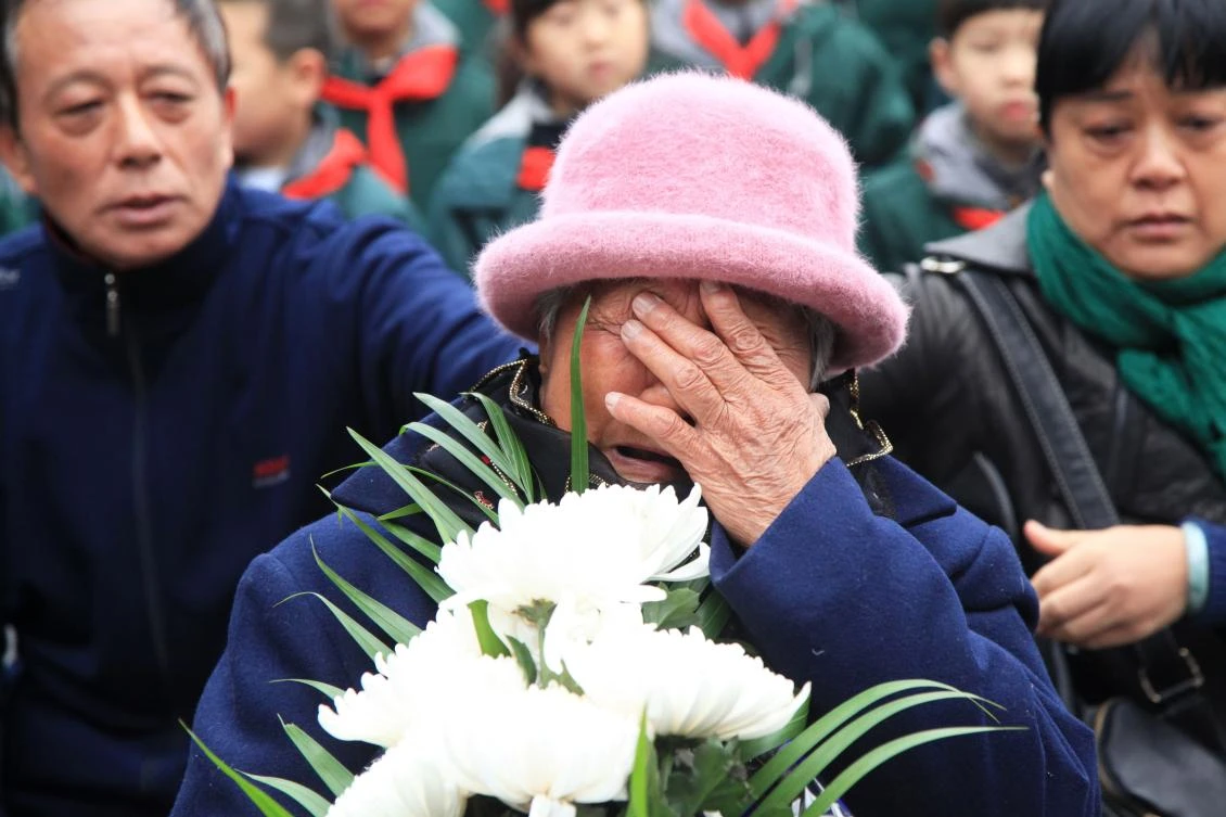 A survivor cries during a memorial ceremony at the Memorial Hall of the Victims in Nanjing Massacre by Japanese Invaders ahead of China’s National Memorial Day for Nanjing massacre victims in Nanjing city, east China’s Jiangsu province on December 4, 2017. (AFP)