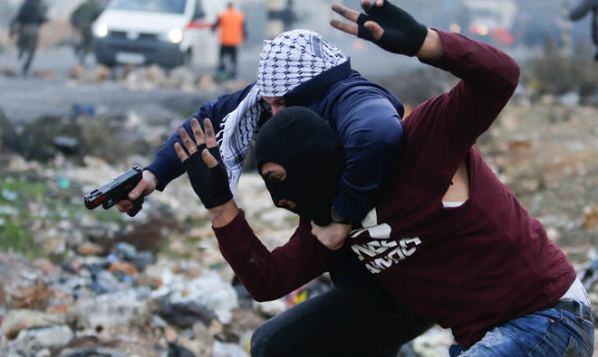 Undercover Israeli police arrest a Palestinian demonstrator during clashes following protests in the West Bank city of Ramallah, on Wednesday. (AP)