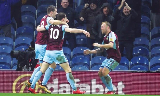 Burnley celebrate their winning goal against Stoke City on Tuesday night. (AP)