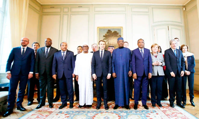 From left, Belgian Prime Minister Charles Michel, Burkina Faso's President Roch Marc Christian Kabore, Mauritania's President Mohamed Ould Abdel Aziz, Mali’s President Ibrahim Boubacar Keita, France's President Emmanuel Macron, Chad's President Idriss Deby, Niger's President Mahamadou Issoufou, German Chancellor Angela Merkel, Italy's Prime Minister Paolo Gentiloni and France's Defense Minister Florence Parly pose for a family photo during a summit of the G-5 Sahel anti-terror coalition at the Chateau de La Celle in La Celle-Saint-Cloud, west of Paris, on Wednesday. (AFP)