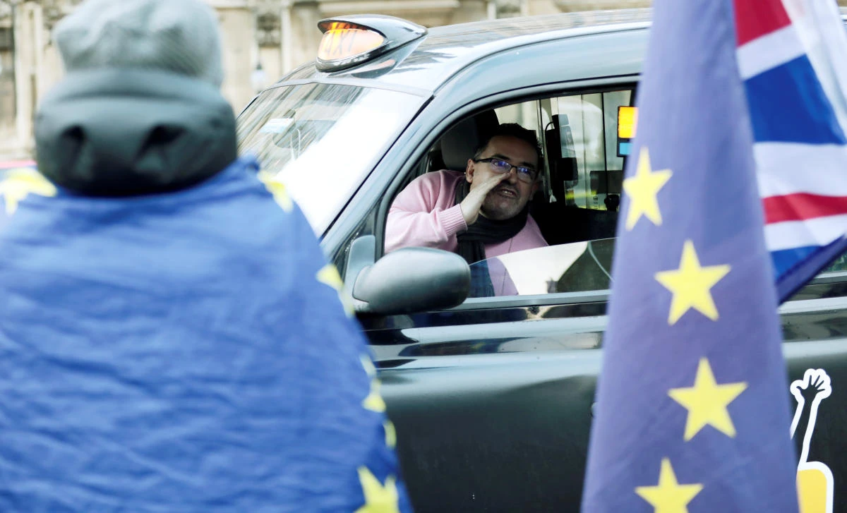 Above, a cab driver shouts at anti-Brexit protesters demonstrating outside the Houses of Parliament in London, Britain on Thursday, December 13. (Reuters)