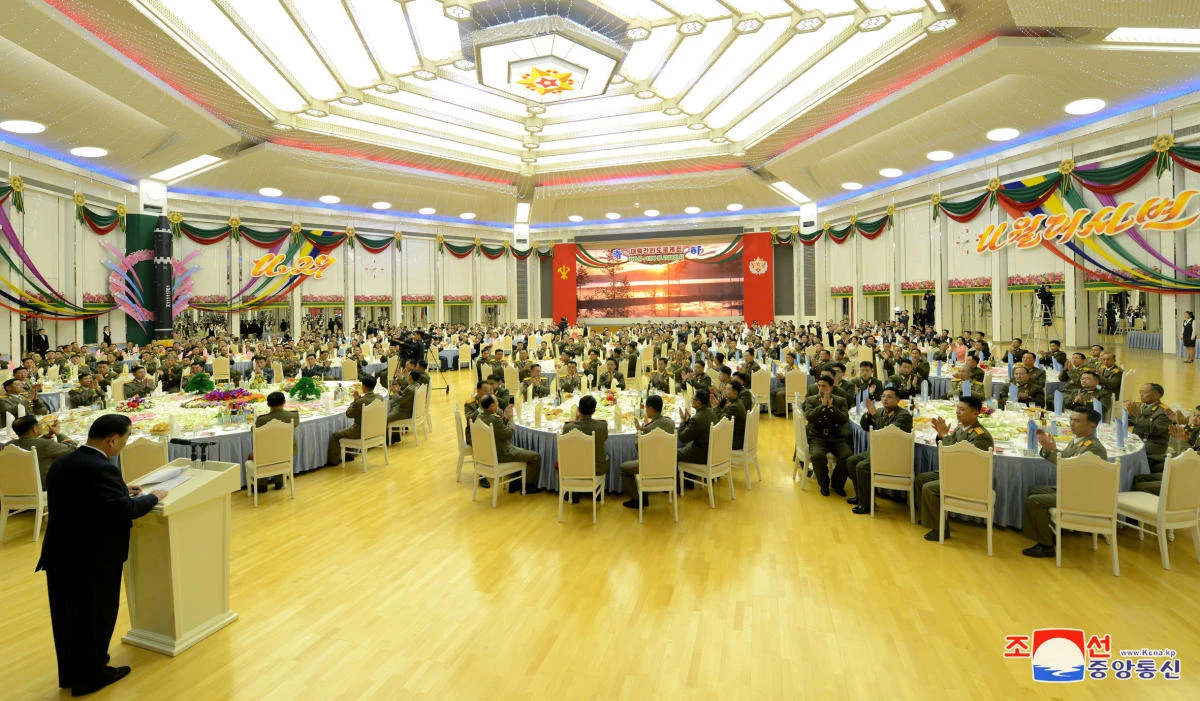 Above, the Central Committee of the Workers’ Party of Korea hosts a reception in honor of the contributors of the successful test-fire of intercontinental ballistic missile Hwasong-15 in this photo released by the Korean Central News Agency on December 13. (KCNA via Reuters)