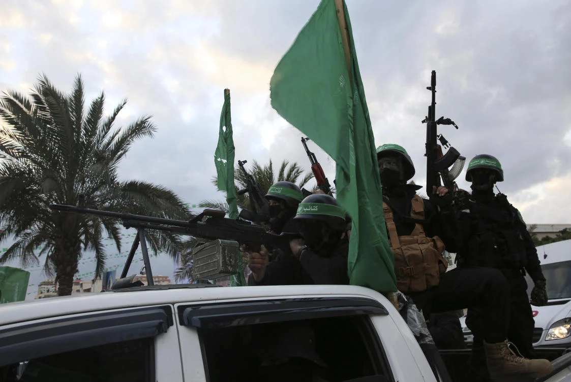 Masked militants from the Izzedine Al-Qassam Brigades, a military wing of Hamas, ride vehicles as they commemorate the 30th anniversary of their group, in Gaza City, Wednesday, Dec. 13, 2017. (AP/Adel Hana)