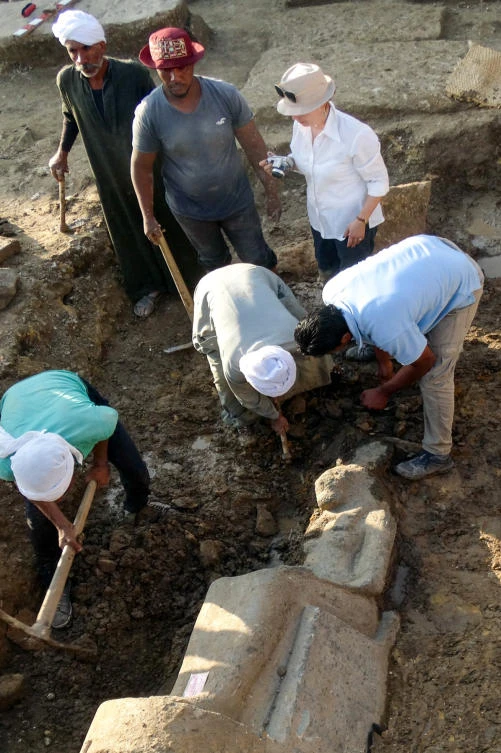 A handout picture provided by the Egyptian Ministry of Antiquities on Dec. 4, 2017 shows archaeologists unearthing an ancient Egyptian statue, found at the site of a dig in the Colossi of Memnon area across the Nile from Egypt’s southern city of Luxor. The ministry said on December 3 that an Egyptian-European mission discovered 27 fragmented statues of the lion-headed goddess Sekhmet, known as The Lady of War, in an area off the west bank of the Nile from Luxor, which used to be a capital for ancient Egypt.(AFP/HO/Egyptian Ministry of Antiquities)