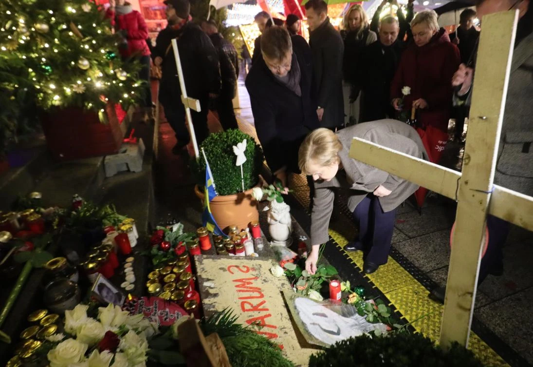German Chancellor Angela Merkel pays her respects to the victims by laying flowers as she visits the Christmas market at Breitscheidplatz in western Berlin’s main shopping district on Dec. 12, 2017, almost a year after an Islamist attacker hijacked a truck and plowed into shoppers. (AFP/dpa/Michael Kappeler)