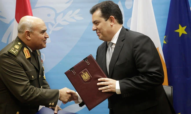 Egypt Minister of Defense Sedki Sobhy, left, and Cyprus' Defense Minister Christoforos Fokaides shake hands after signing an agreement at the Defense Ministry in Nicosia on Tuesday. (AP)