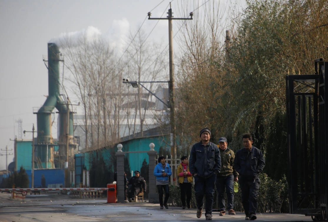 Above, smoke billows from a chimney as workers leave a factory in rural Gaoyi county, known for its ceramics production, near Shijiazhuang, Hebei province. The Chinese central government has ordered the 28 cities to reduce emissions. (Reuters)