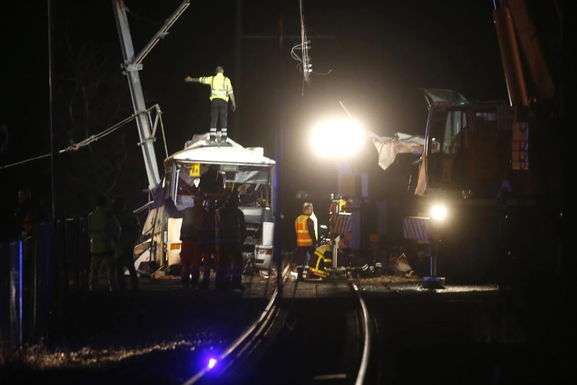 Firefighters and police work at the site of the accident in Millas, southern France, where a train crashed into a school bus at a level crossing. (AFP)