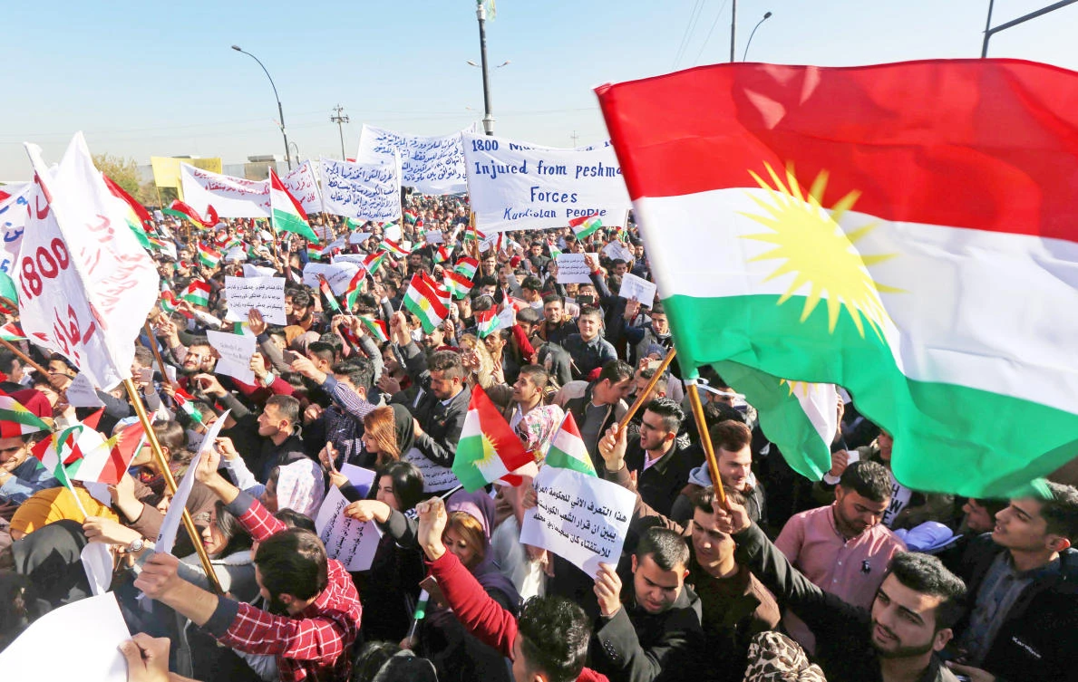 Iraqi Kurdish students of the Salahaddin University wave the Kurdish flag as they demonstrate in Irbil, the capital of autonomous Iraqi Kurdistan region, on Monday, against the Iraqi premier. (AFP)