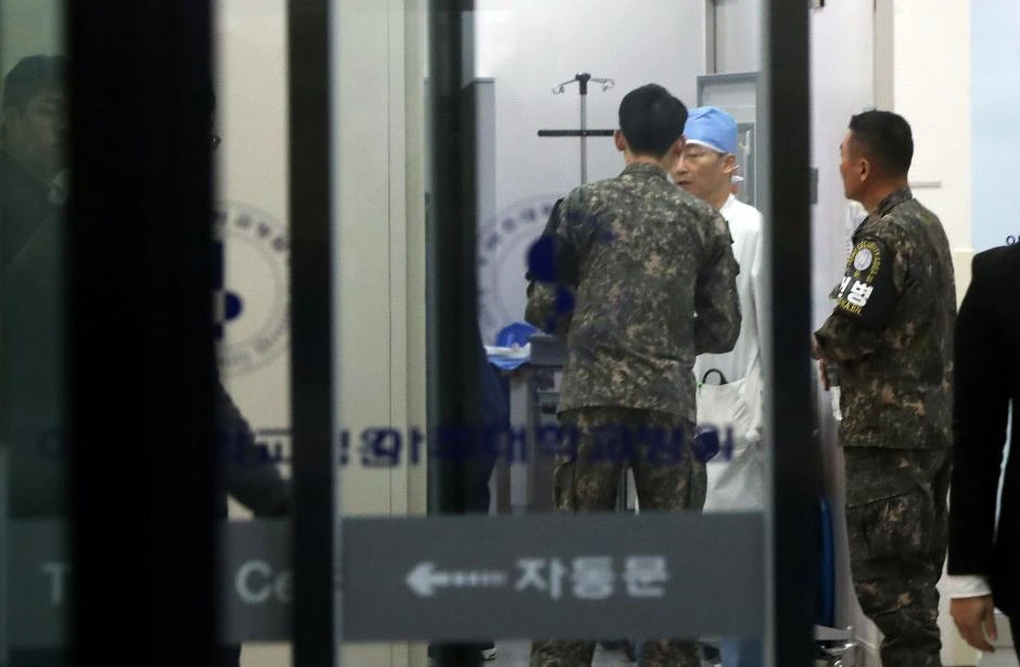 A South Korean soldier talks with a surgeon at a hospital where a North Korean soldier who defected to the South is hospitalized. (Reuters)