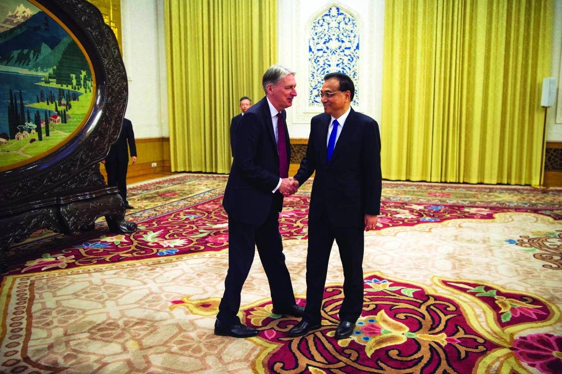 China’s Premier Li Keqiang, right, meets Britain’s Chancellor of the Exchequer Philip Hammond in Beijing. (AP)