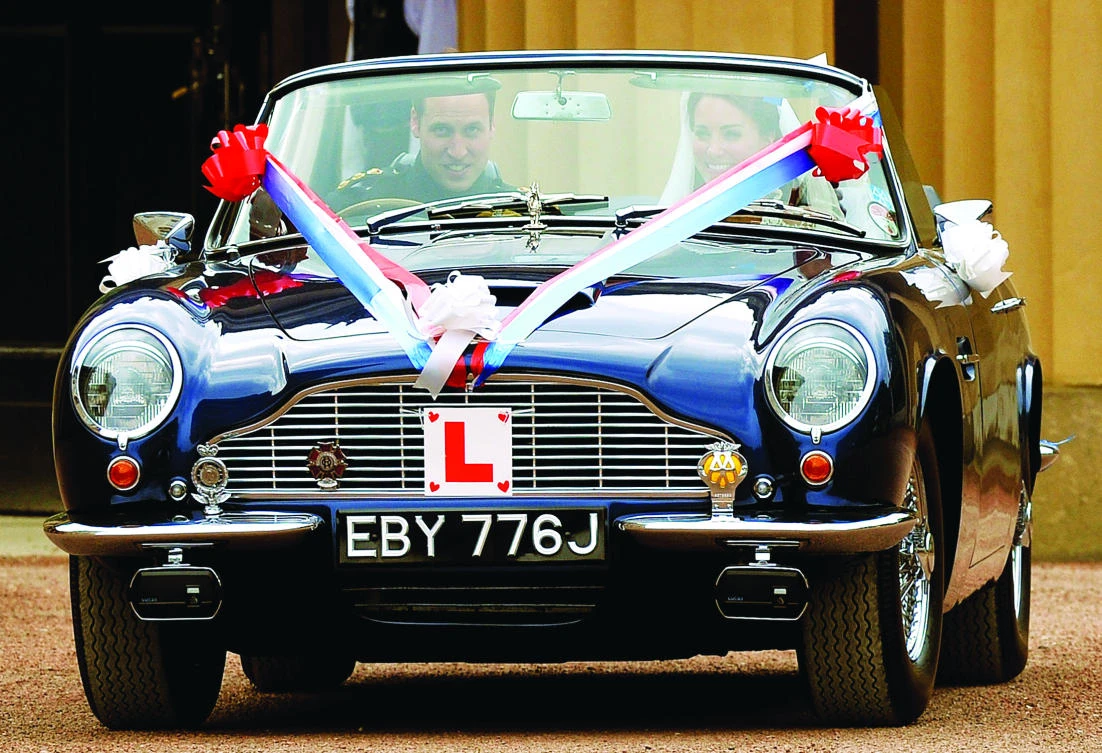 Britain’s Prince William and his wife Catherine drive from Buckingham Palace in an Aston Martin DB6 Mark 2, after their wedding in central London on April 29, 2011. (Reuters)