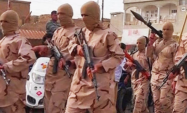 In this photo released on April 25, 2015 by a militant website, which has been verified and is consistent with other AP reporting, young boys known as the "caliphate cubs" hold rifles as they parade after graduating from a religious school in Tal Afar, near Mosul, northern Iraq. (AP)