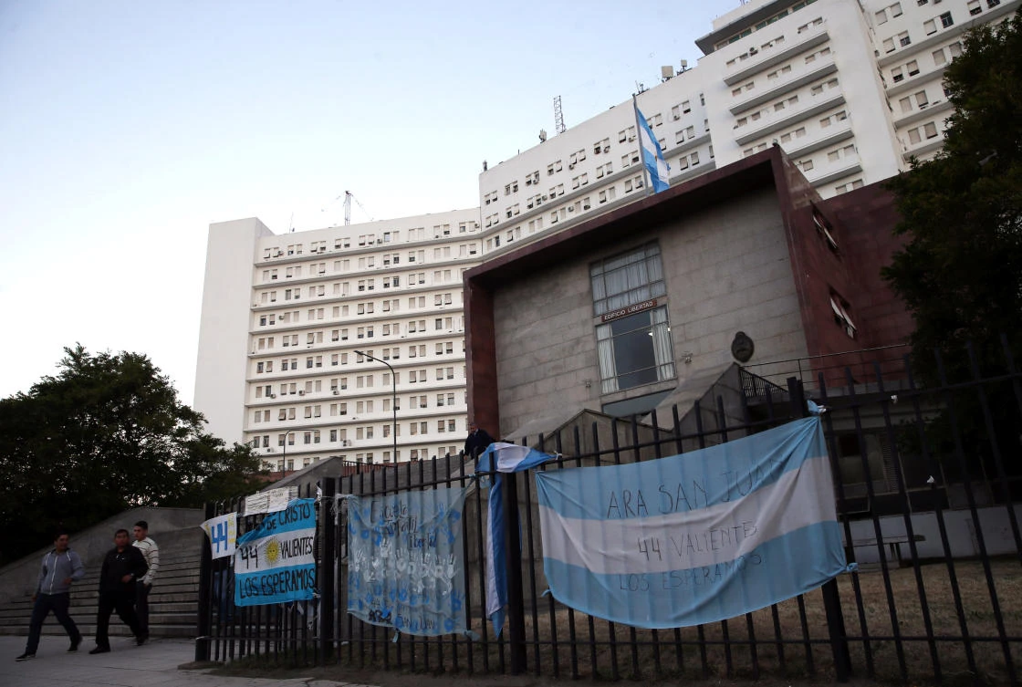 Above, signs in support of the 44 crew members of the missing at sea ARA San Juan submarine hang from a fence of the Argentine Navy headquarters in Buenos Aires. (Reuters)