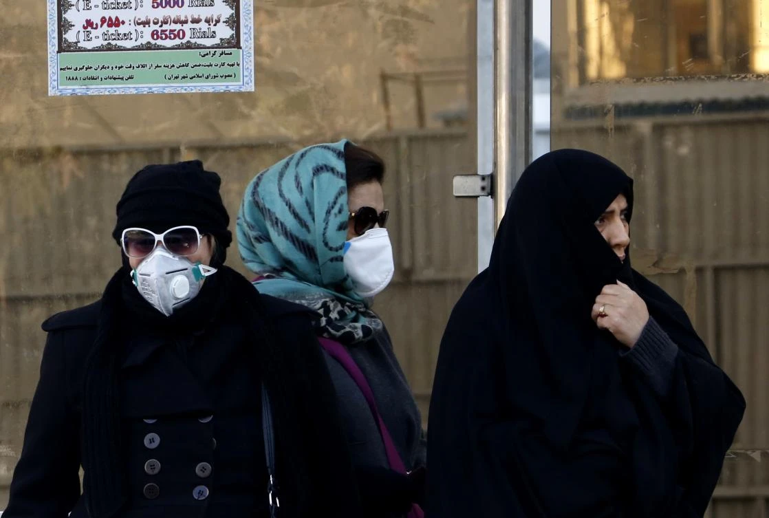 Every year, Tehran suffers some of the worst pollution in the world when cool temperatures cause an effect known as “temperature inversion.” Above, Iranian women wear face masks at a bus stop in Tehran. (AFP)