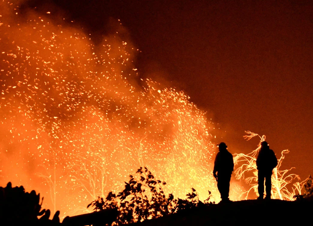 Firefighters keep watch on the Thomas wildfire Montecito. Nearly 8,500 firefighters are battling Thomas Fire, which began December 4 and has destroyed more than 1,000 structures and threatened 18,000 more. (Reuters)