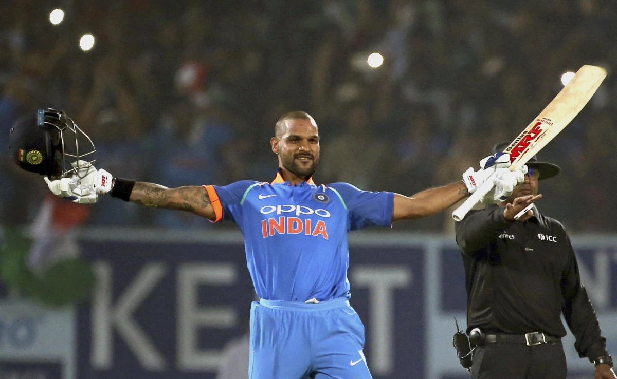India’s Shikhar Dhawan raises his bat and helmet to celebrate a century during their third and final one-day international game against Sri Lanka in Visakhapatnam, India, Dec. 17, 2017. (AP)