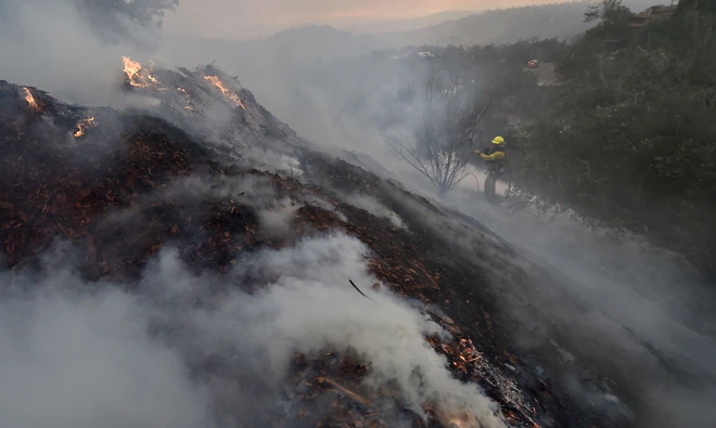 Flames threaten rich California enclave; residents flee