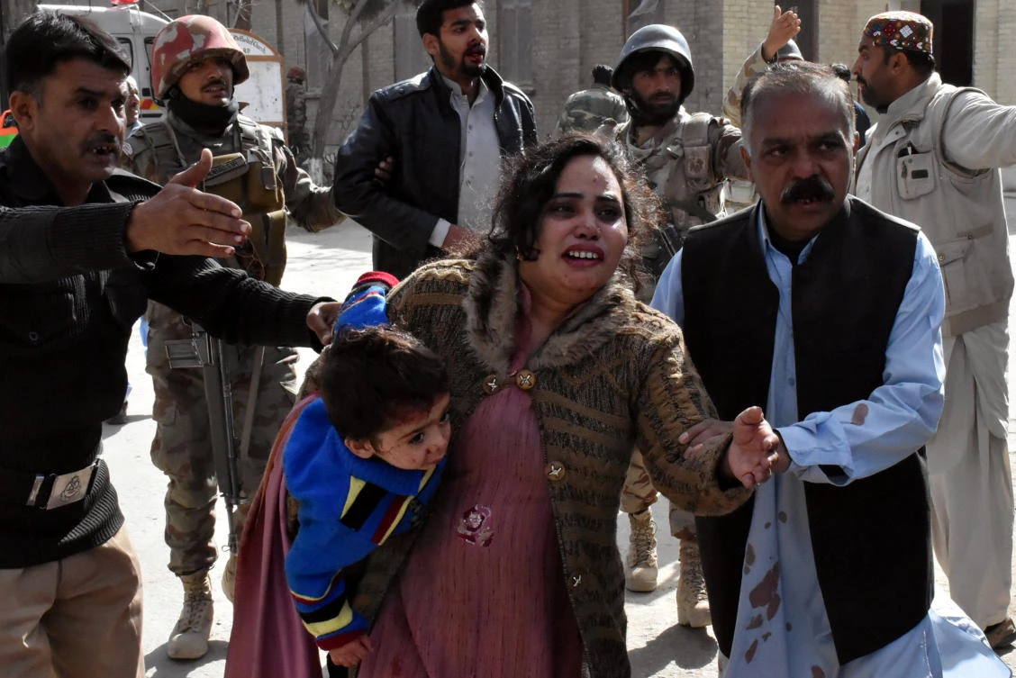 A policeman guides a family after after gunmen attacked the Bethel Memorial Methodist Church in Quetta, Pakistan December 17, 2017. (Reuters)
