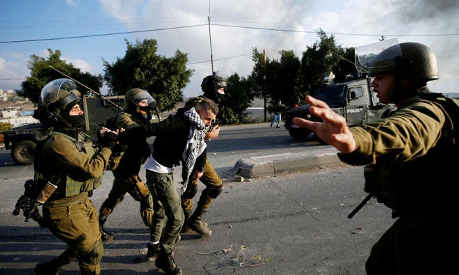 Israeli soldiers detain a Palestinian during clashes at a protest against Donald Trump's decision to recognize Jerusalem as the capital of Israel, near the West Bank city of Nablus on Dec. 15, 2017. (Reuters)